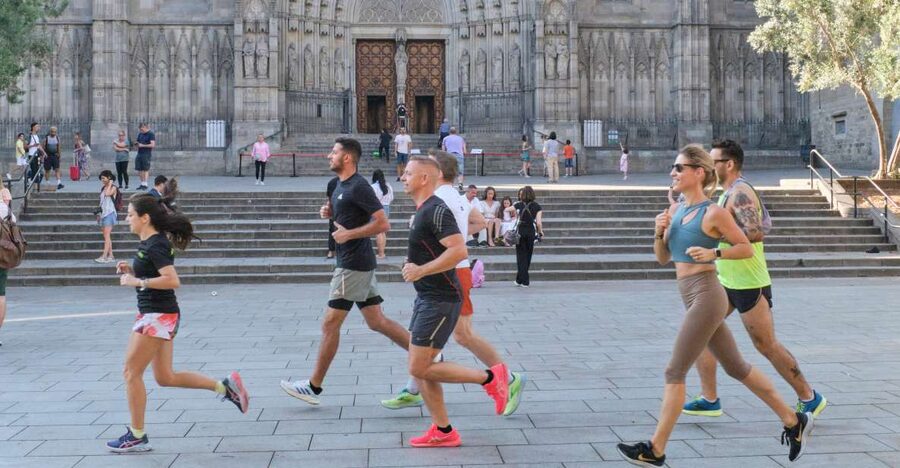 Barcelona: City Highlights Guided Running Tour - Sagrada Família from the outside, with the unfinished-story context