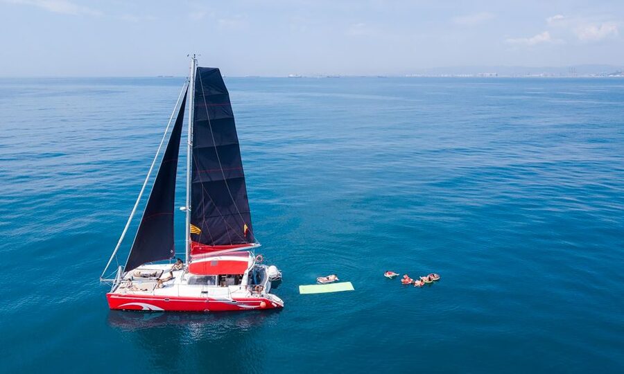 Barcelona: Sunset or Day Catamaran Cruise with Tapa & Drink - What onboard feels like: nets, sun, shade, and room to breathe