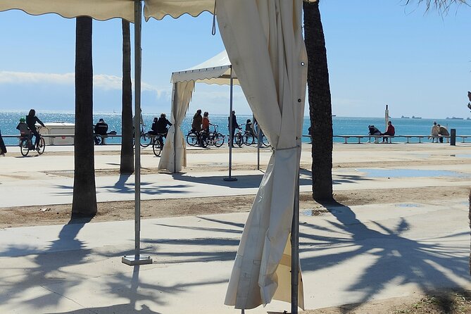 Eco-friendly Barcelona Bike Tour from a Local Perspective - Mediterranean Sea time: beaches, skyline, and a boat with snacks