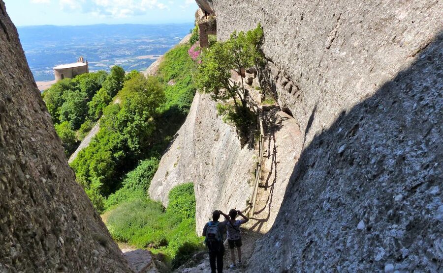 From Barcelona: Montserrat Full-Day Trip with Guided Hike - Coming down through shrines and back toward the monastery